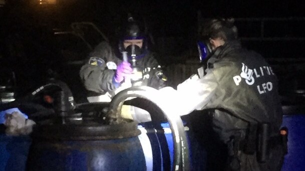 Before it even arrives here, drug cooks in The Netherlands are making MDMA and ecstasy by the ton. Here Dutch authorities examine barrels of precursor chemicals illegally dumped in a Brabant forest.