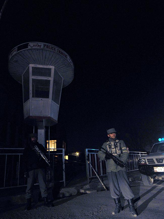 Afghan policemen stand guard near the site of a blast at the Kabul Serena Hotel in Kabul, 14 January 2008. Picture: AFP