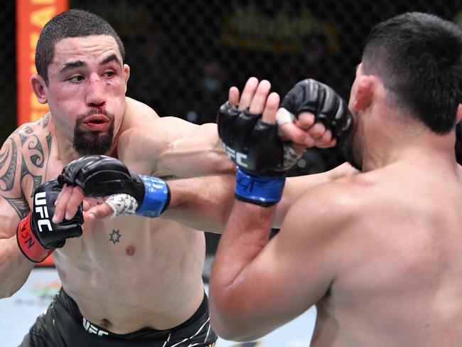 LAS VEGAS, NEVADA - APRIL 17: In this handout photo, (L-R) Robert Whittaker of Australia punches Kelvin Gastelum in a middleweight fight during the UFC Fight Night event at UFC APEX on April 17, 2021 in Las Vegas, Nevada. (Photo by Chris Unger/Zuffa LLC)