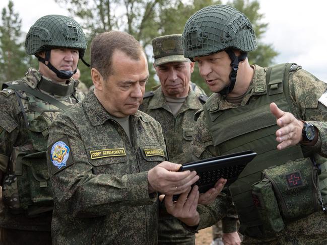 Russia's former president and now serving as deputy chairman of the country's Security Council, Dmitry Medvedev (L), visits the Totsky military training field outside Siberian city of Orenburg on July 14, 2023. (Photo by Yekaterina SHTUKINA / SPUTNIK / AFP)