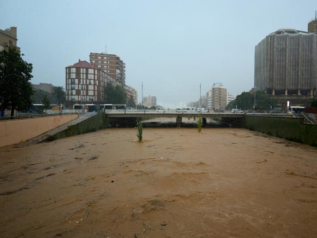 A canal near the centre of Malaga, which is typically dry, is overflowing. Picture: Getty Images