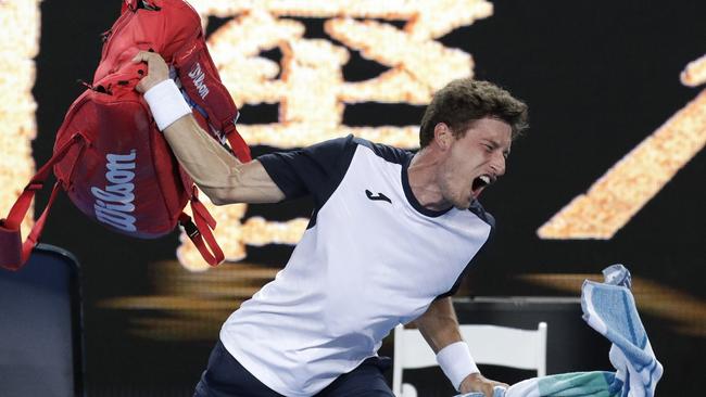 Pablo Carreno Busta prepares takes out his frustration on his bag. (AP Photo/Aaron Favila)