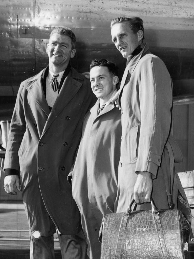 Merv McIntosh pictured with two teammates in Adelaide before an interstate game.