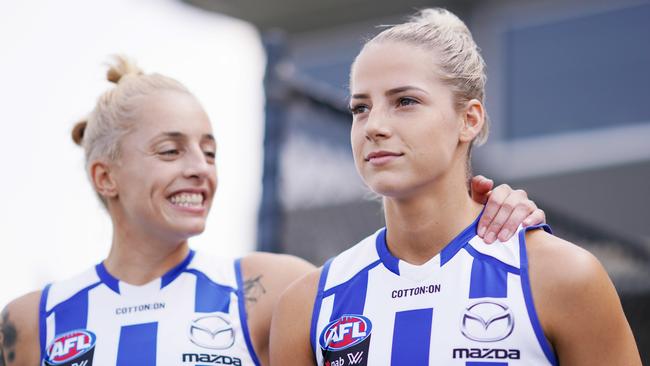 Kaitlyn Ashmore and Elisha King of the Kangaroos walk out during the Round 1 AFLW match between the Melbourne Demons and North Melbourne Kangaroos at Casey Fields in Melbourne, Saturday, February 8, 2020. (AAP Image/Michael Dodge)