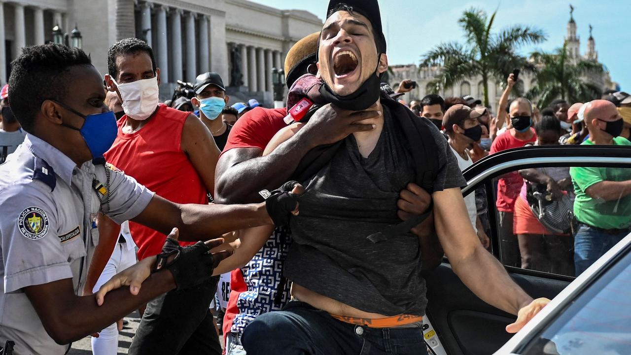 Police arrest a protester. Picture: Yamil Lage/AFP