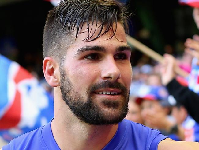 MELBOURNE, AUSTRALIA - MARCH 27: Marcus Adams of the Bulldogs high fives fans after winning the round one AFL match between the Western Bulldogs and the Fremantle Dockers at Etihad Stadium on March 27, 2016 in Melbourne, Australia. (Photo by Quinn Rooney/Getty Images)