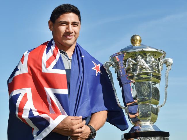 Jason Taumalolo draped in a New Zealand flag with the Rugby League World Cup. Picture: Katrina Bridgeford.