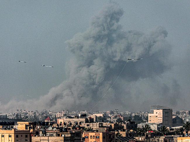 Kites fly in Rafah as a smoke plume erupts during Israeli bombardment on Khan Yunis in the southern Gaza Strip, amid ongoing battles between Israel and Hamas. Picture: AFP