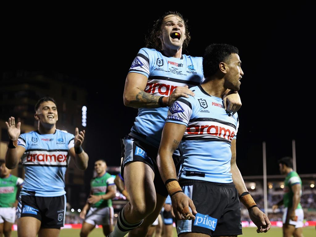 SYDNEY, AUSTRALIA - MARCH 31: Ronaldo Mulitalo of the Sharks celebrates scoring a try with Nicho Hynes of the Sharks during the round four NRL match between Cronulla Sharks and Canberra Raiders at PointsBet Stadium, on March 31, 2024, in Sydney, Australia. (Photo by Cameron Spencer/Getty Images)