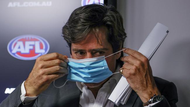 AFL CEO Gillon McLachlan dons a mask at a press conference last year. Picture: Michael Klein