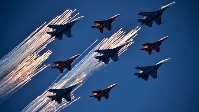 Russian Su-27 jet fighters and MIG 29 jet fighters fly over Red Square. Picture: AFP.