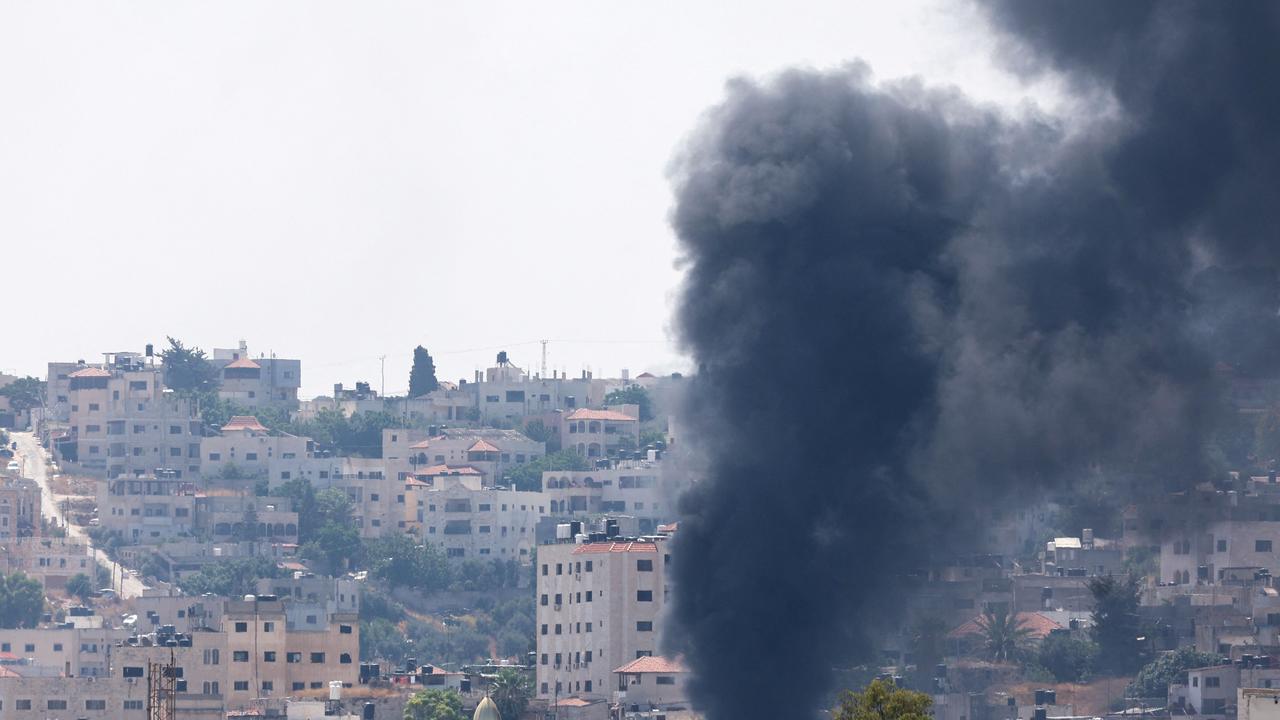 Smoke billows during an Israeli army operation in Jenin in the occupied West Bank on July 3, 2023. Photo by Jaafar ASHTIYEH / AFP