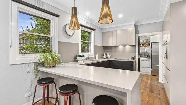 Waterfall benches, pendant lighting and a walk-in pantry feature in the updated kitchen.