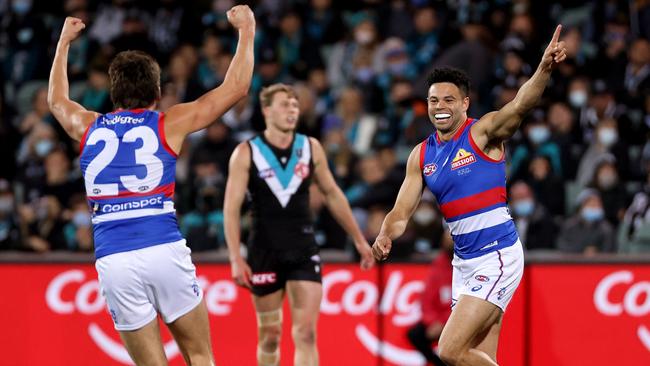 Bulldogs Laitham Vandermeer and Jason Johannisen celebrate as a dejected Xavier Duursma looks on. Picture: James Elsby/AFL Photos