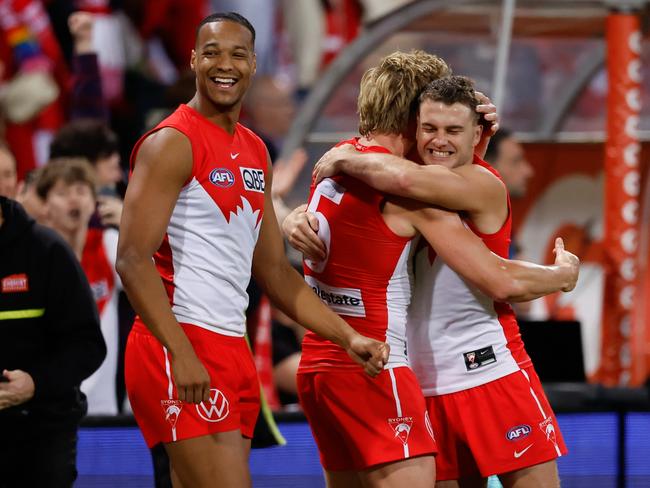 Swans Joel Amartey, Isaac Heeney and Tom Papley celebrate during the preliminary final.