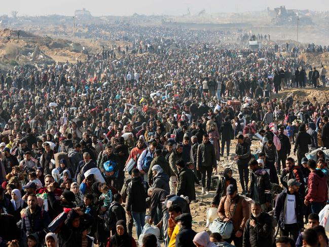 People walk along Gaza's coastal al-Rashid Street to cross the Netzarim corridor from the southern Gaza Strip into the north. Picture: Omar AL-QATTAA / AFP