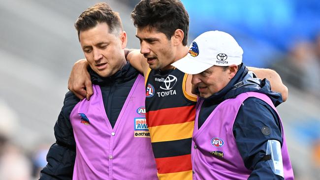 Shane McAdam leaves the field after injuring his ankle. Picture: Steve Bell/Getty Images