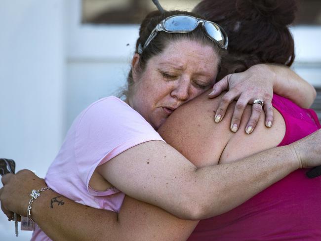 Carrie Matula embraces a woman after a fatal shooting at the First Baptist Church in Sutherland Springs, Texas. Picture: AP.