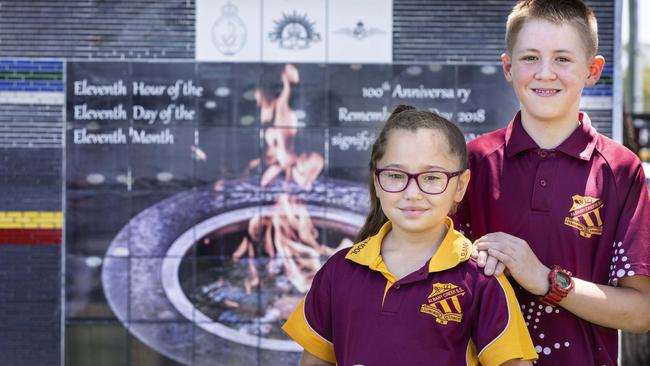 Albany Creek State School students Kaelyn Mow-Richardson and Lachlan Arkell with the latest phase of a multi-faceted memorial to war veterans which was unveiled in 2018. Picture: AAP/Renae Droop