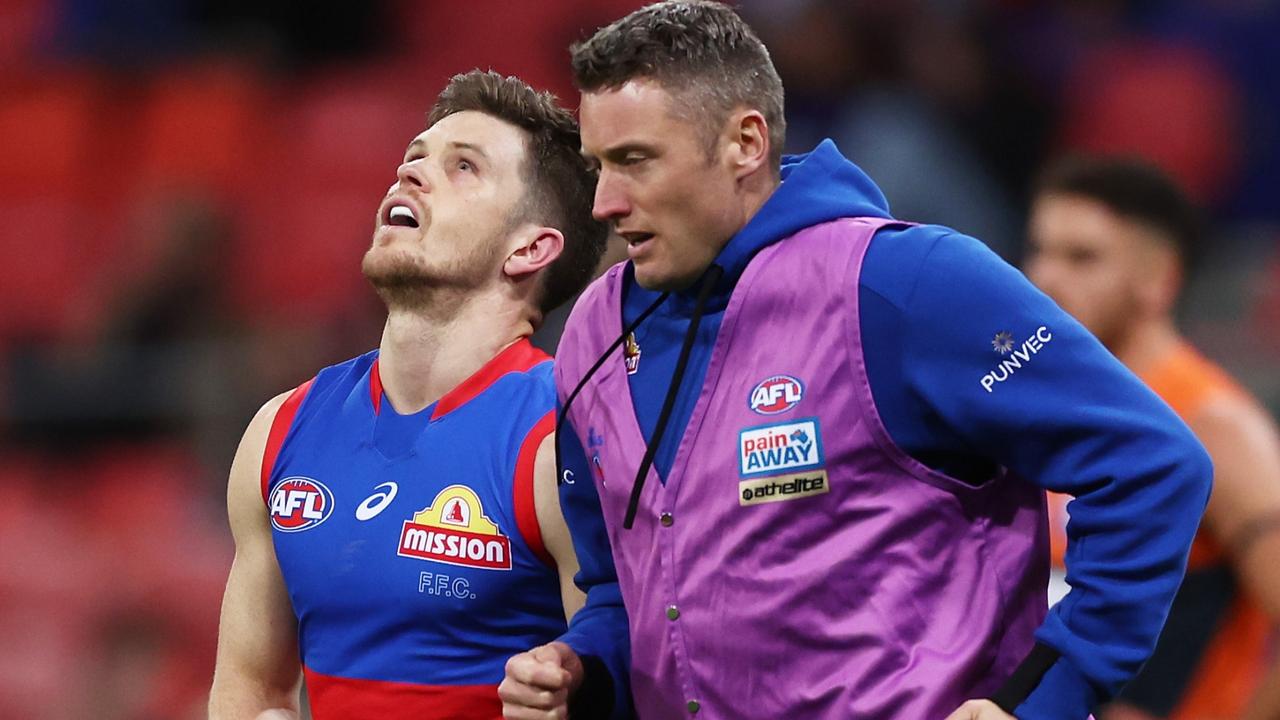 Taylor Duryea grimaces in pain has he leaves the field injured. Picture: Matt King/AFL Photos/Getty Images