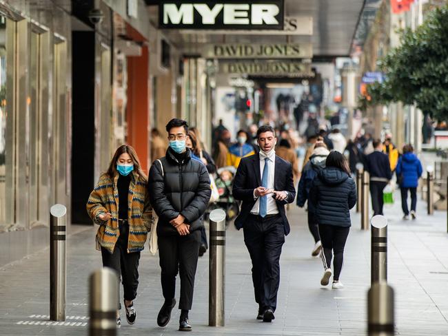 MELBOURNE, AUSTRALIA - JUNE 11: People are seen walking through the Bourke Street Mall on June 11, 2021 in Melbourne, Australia. Melbourne's lockdown measures were lifted as of 12:01 on Friday, although some COVID-19 restrictions remain in place as Victoria continues to record new coronavirus cases. Masks remain mandatory outdoors, while the five reasons to leave home will no longer apply. Melbourne residents will still be subject to a 25km travel limit from their homes and are not permitted to travel to regional areas. Visitors are still not permitted in homes but outdoor gatherings are allowed for up to 10 people while hospitality and retail are permitted to reopen subject to density limits. (Photo by Darrian Traynor/Getty Images)