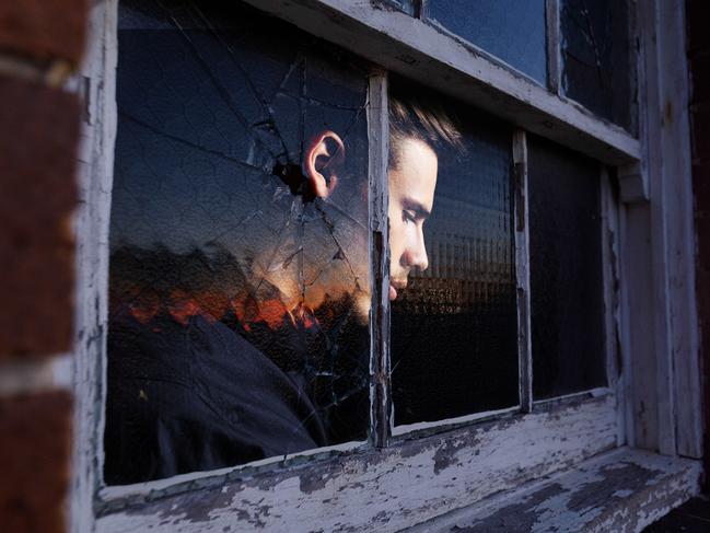 27 September 2024; Photo comp of a photo of a window of the dilapidated former Rozelle Hospital in Sydney, previously called Callan Park, was one of the largest mental asylums in the nation before it was shut and an image of a man's forlorn face looking outside the window; Sources: Max Mason-Huber and iStock. Photo comp by Emilia Tortorella. Ratio 4:3.