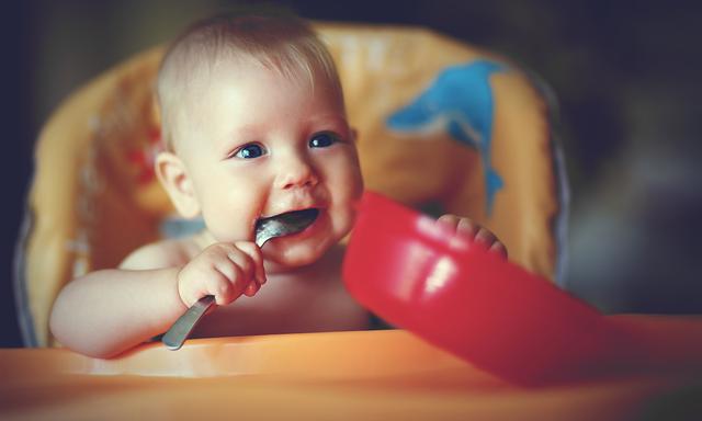 baby boy spoon eats itself