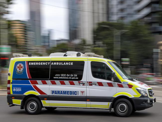 MELBOURNE, AUSTRALIA - NewsWire Photos FEBRUARY 13, 2022: An ambulance speeds away from the Royal Melbourne Hospital. Ambulance, Generic.Picture: NCA NewsWire / David Geraghty