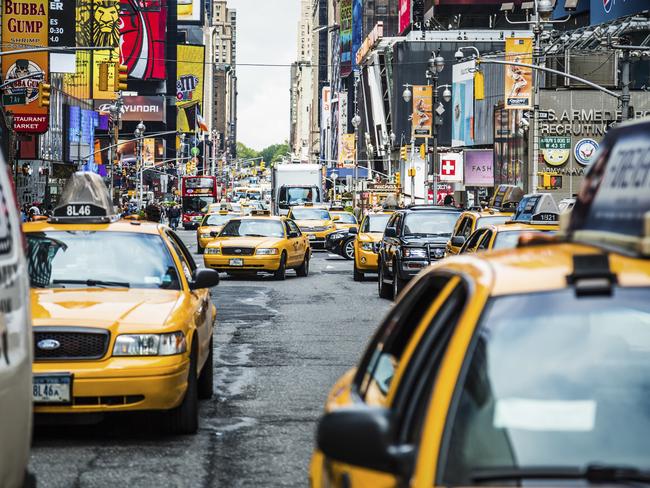 Heavy traffic on busy famous 7th Avenue near Times Square in New York City, USA in afternoon. Vast number of vehicles hit the streets and avenues of Manhattan every day. Almost half of cars are yellow taxis (well recognized city icon).