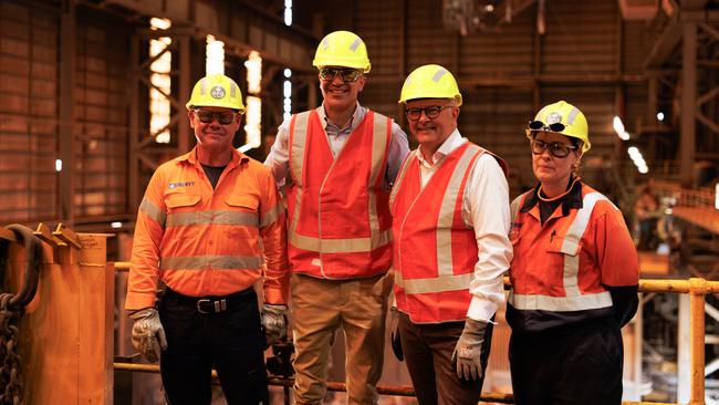 Prime Minister Anthony Albanese (second right) and South Australian Premier Peter Malinauskas (second left) pose for a photograph with workers inside the Whyalla steelworks in Whyalla, South Australia, Wednesday, February 19, 2025. A $2.4 billion government package will keep Whyalla's steelworks running and its debts paid while a new owner is found, after it was placed in administration. (AAP Image/Isabella Ward) NO ARCHIVING