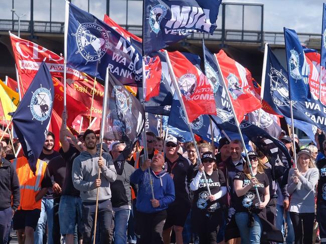 Union members march to Webb Dock during an industrial action dispute in Melbourne, Friday, December 8, 2017. Scores of unionists are descending on the Melbourne port as a dispute escalates after a casual worker was denied further shifts. (AAP Image/Luis Enrique Ascui) NO ARCHIVING