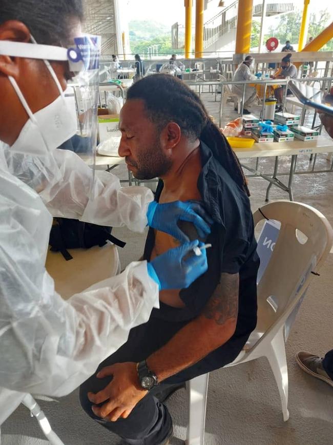 Larsen Marape, the PNG Prime Minister’s brother, receives one of the precious first doses donated by Australia for frontline health workers in the impoverished country.