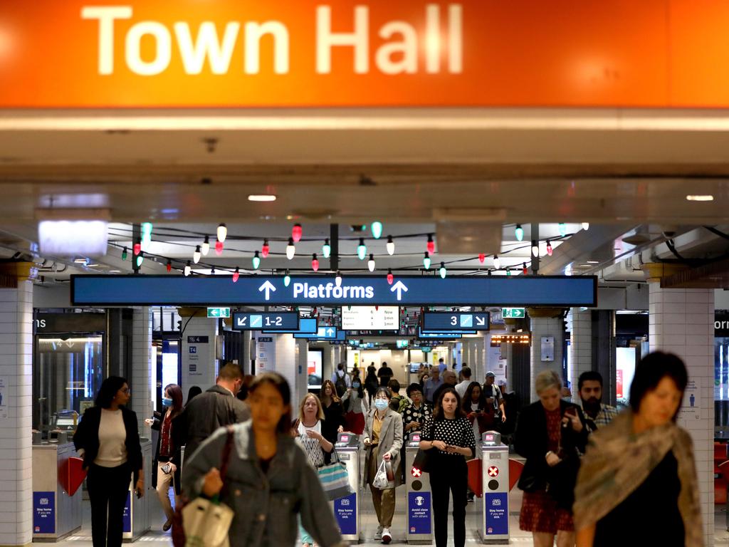 SYDNEY, AUSTRALIA - NewsWire Photos DECEMBER 14, 2020: Commuters coming out of Town hall train station just before 9am, Sydney CBD is slowly getting busier after the easing of Covid restrictions bringing workers back to the CBD.Picture: NCA NewsWire / Damian Shaw