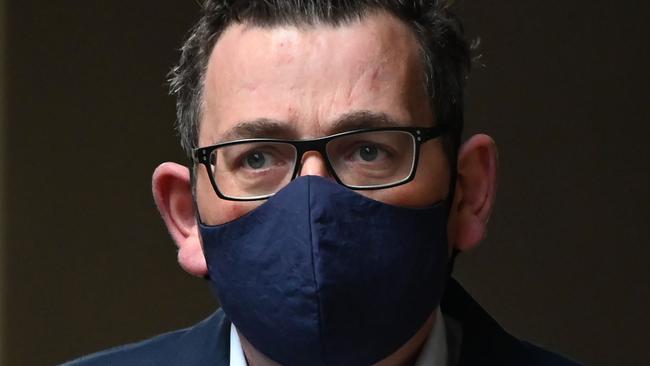 Victorian premier Daniel Andrews wears a mask as he arrives at a press conference. Picture: William West/AFP