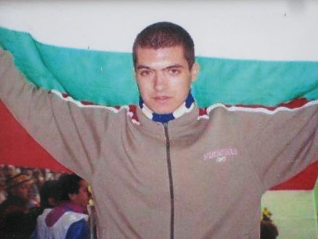 Andrei Monov holding up Bulgarian national flag at a soccer match. Picture: Supplied