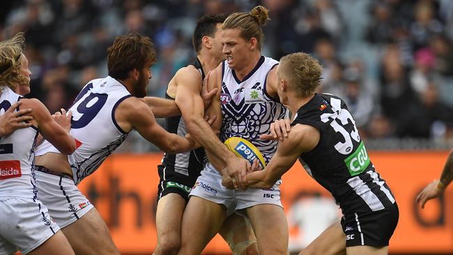 Nat Fyfe of the Dockers makes contact with Collingwood’s Levi Greenwood on Sunday. Picture: Image/Julian Smith