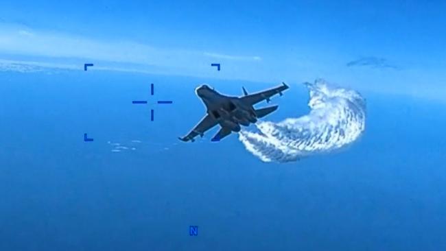 SEVASTOPOL, UKRAINE - MARCH 14: In this screengrab of a video clip released by the United States Defense Department's European Command, a Russian Su-27 fighter jet flies near an American MQ-9 Reaper drone, spraying what the US government says is jet fuel, on March 14, 2023 over the Black Sea near Crimea. On a final pass, the Russian jet allegedly collided with the drone, damaging its propeller, forcing it to be brought down in the Black Sea. (Photo by US Defense Department European Command via Getty Images)