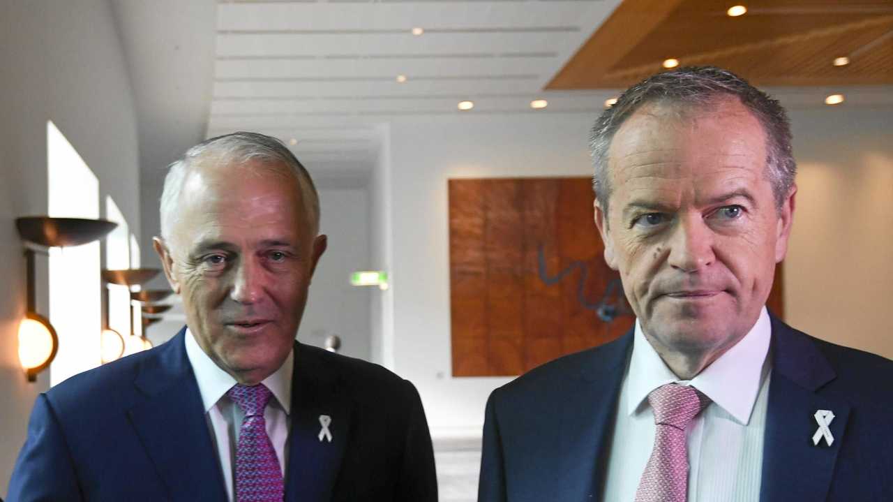 TOKENISM: Australian Opposition Leader Bill Shorten (right) and then Australian Prime Minister Malcolm Turnbull arrive at a White Ribbon Day Parliamentary Breakfast at Parliament House in Canberra last year. There will be white ribbons all over politicians this week but to what avail? Picture: LUKAS COCH