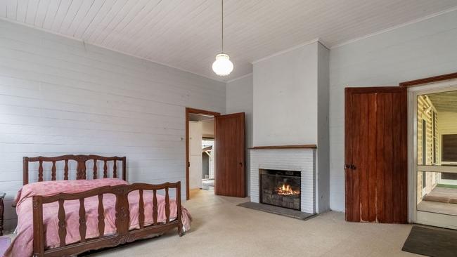 One of the large bedrooms, complete with fireplace.