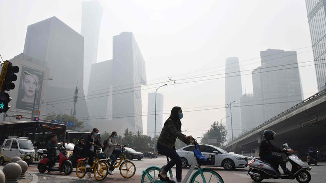 People crossing a road on a polluted day in Beijing in 2020. Picture: AFP