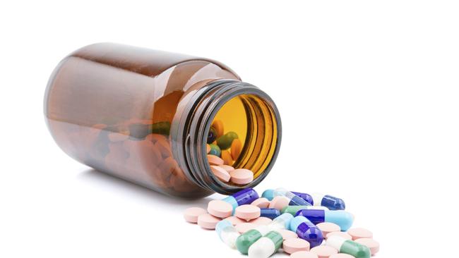 Group of pills in bottle on a white background.