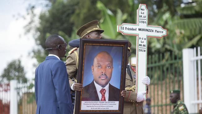 A military officer holds a portrait of late Burundian President Pierre Nkurunziza during his funeral in Gitega, Burundi, June 26, 2020. (Photo by Evrard Ngendakumana/Xinhua via Getty)