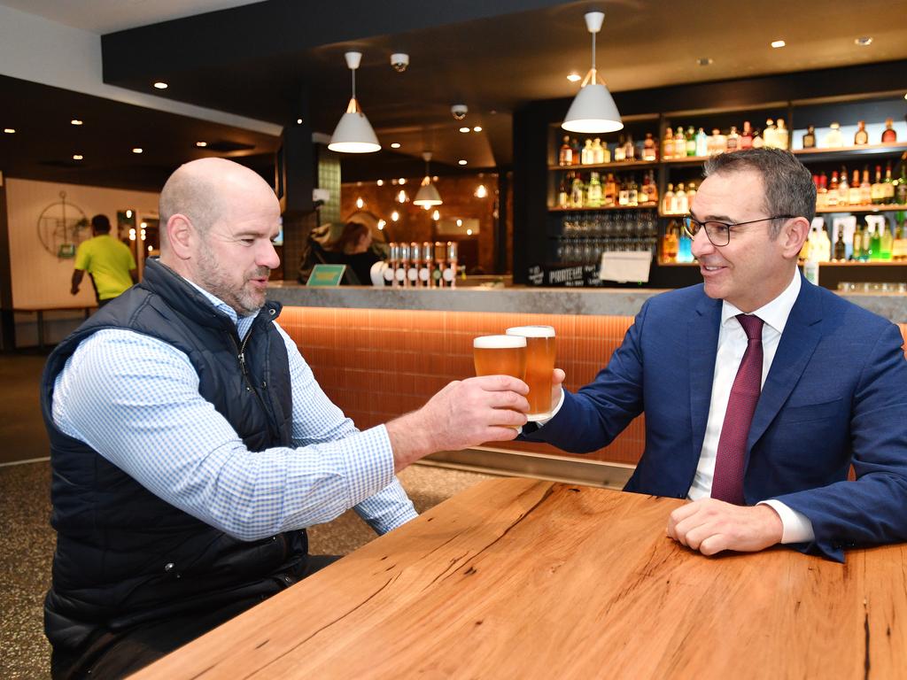 South Australian Premier Steven Marshall and former AFL player Mark Ricciuto are seen enjoying a beer at the Alma Hotel in Adelaide. Picture: David Mariuz/AAP