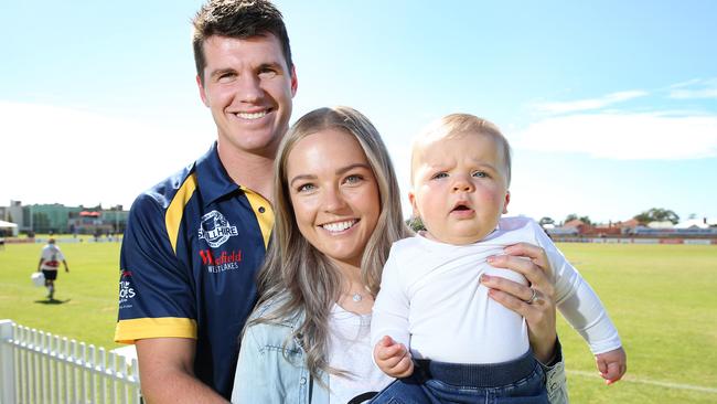 Paul Stewart (Woodville-West Torrens) with his fiancee Kirra-Jae Vince and their daughter Arlo Stewart, 7 months, at Woodville Oval.