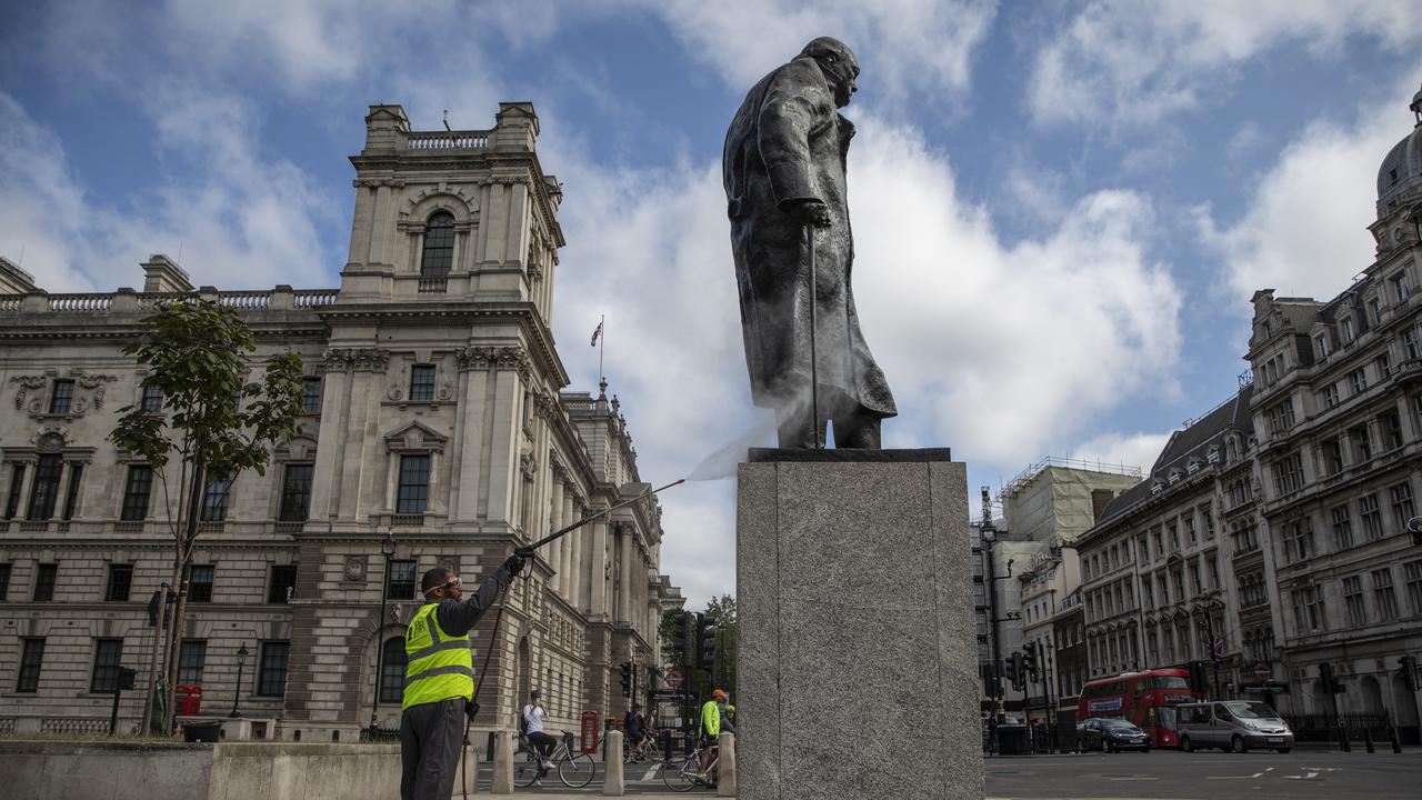 A worker cleans the Churchill statue after it was spray painted with the words 'was a racist'. Picture: Dan Kitwood/Getty Images