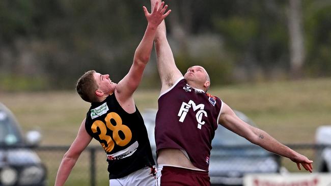 Bacchus Marsh’s Joel Freeman and Melton’s Brett McIntyre. Picture: Andy Brownbill