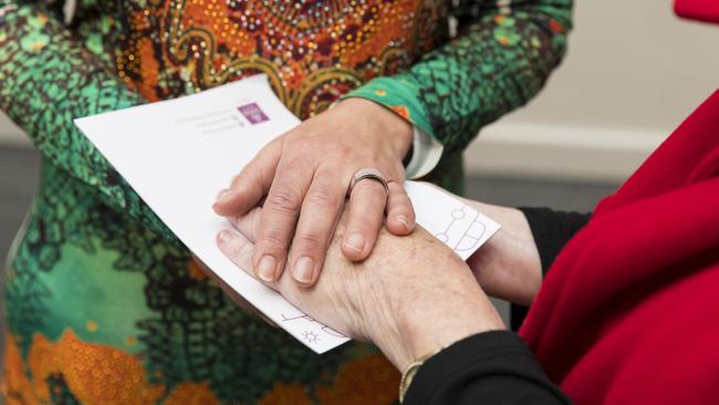 Participants at the conference connect hands to enhance their intuition. Picture: Anna Warr