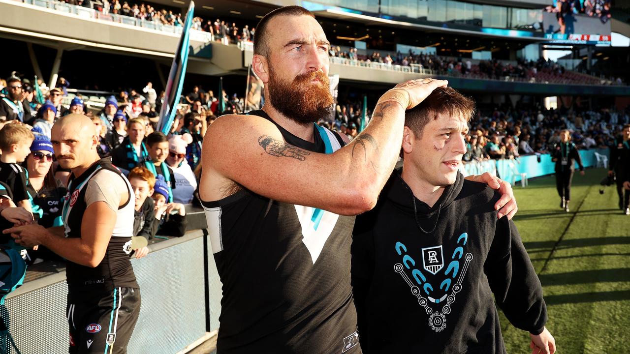 Charlie Dixon with injured teammate Zak Butters. Picture: James Elsby/AFL Photos via Getty Images