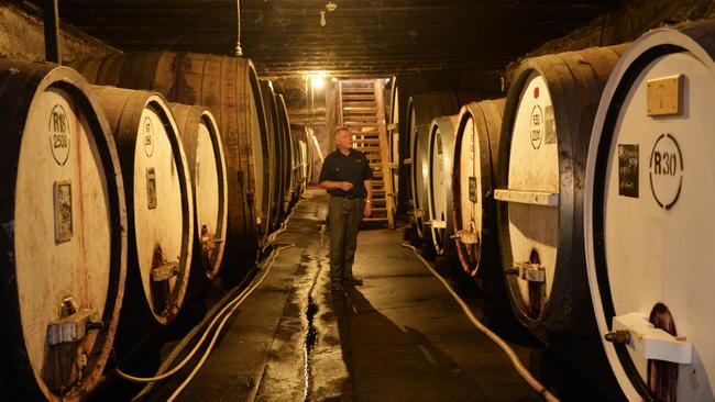 At Tahbilk, head down the wooden stairs to find the original underground cellar, built in 1862.