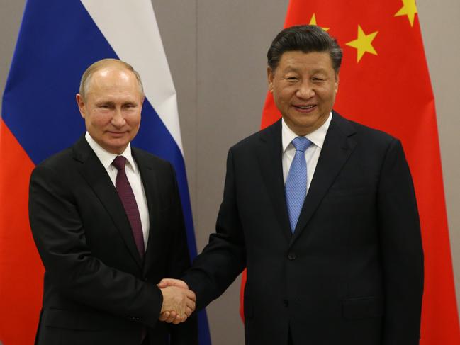 BRASILIA, BRAZIL - NOVEMBER 13: (RUSSIA OUT) Russian President Vladimir Putin (L) greets Chinese President Xi Jinping (R) during their bilateral meeting on November 13, 2019 in Brasilia, Brazil. The leaders of Russia, China, Brazil, India and South Africa have gathered in Brasilia for the BRICS leaders summit. (Photo by Mikhail Svetlov/Getty Images)